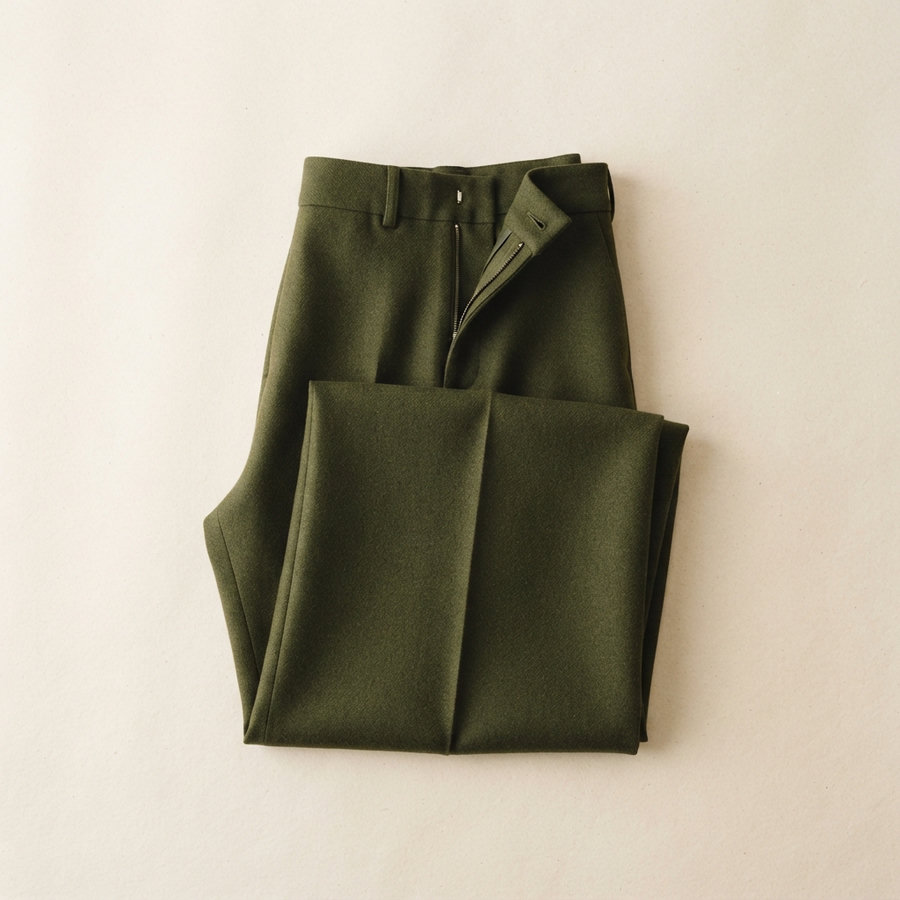 A pair of folded deep-olive wide-leg wool trousers.